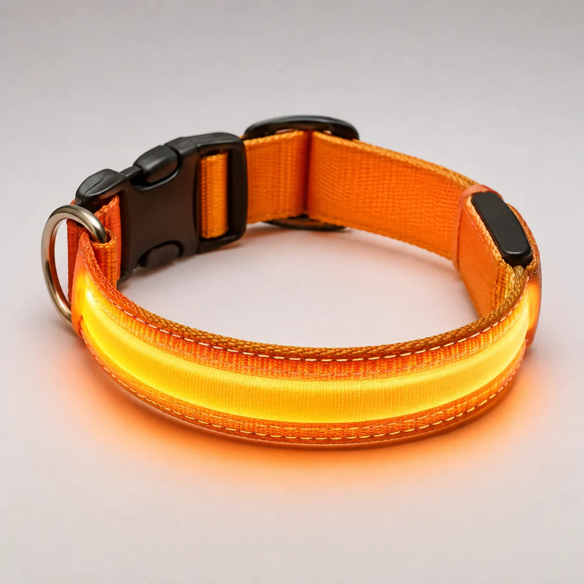 dog led light for collar, orange, glowing, product close-up